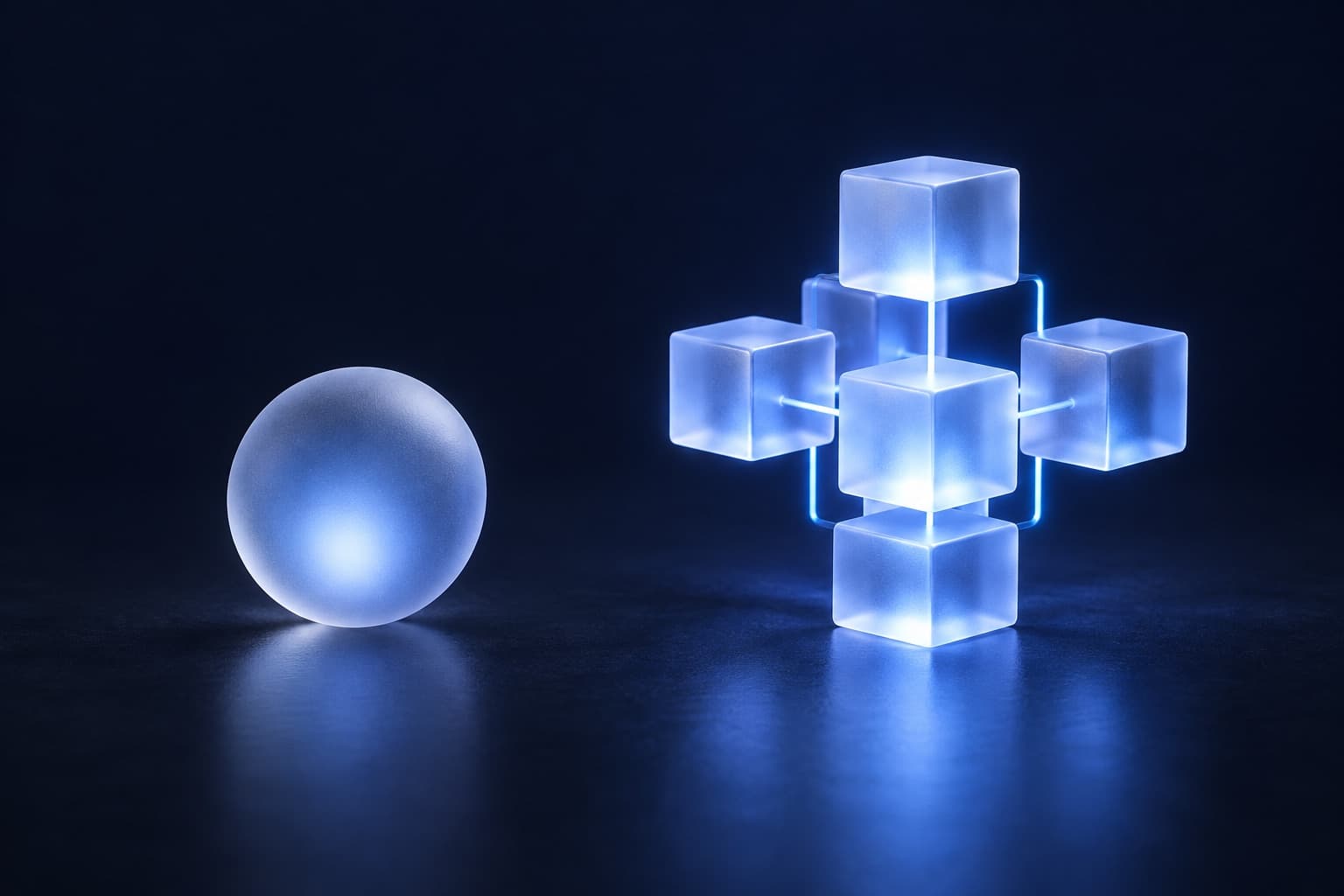 A single glass sphere beside a structure assembled from connected glass blocks